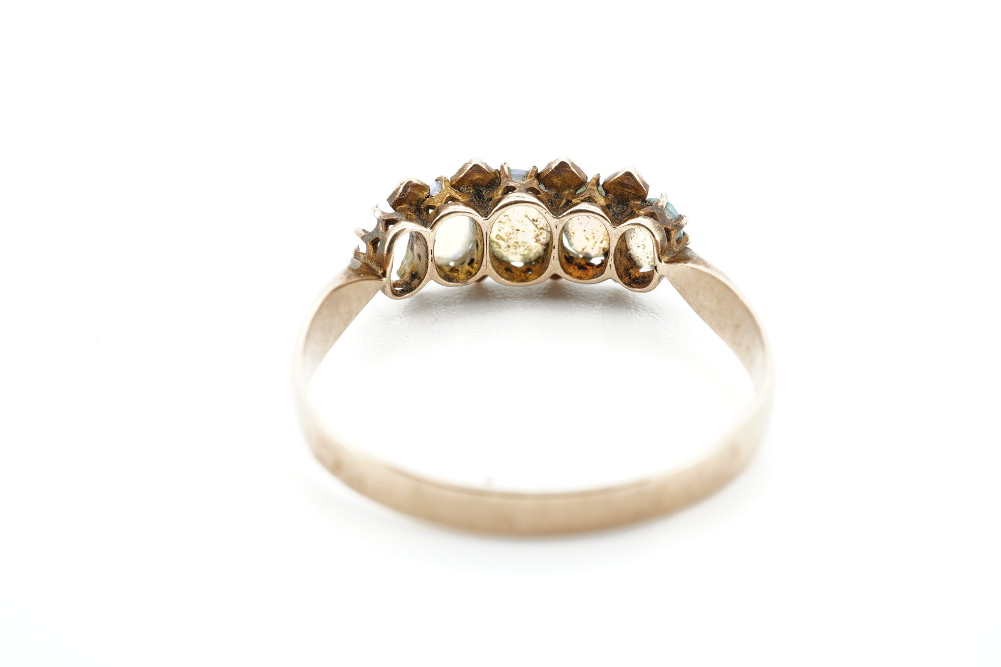 An early 20th century 9ct gold and opal cluster cluster set ring, size M, a 9ct and four(ex five) stone set opal half hoop ring and an 18ct and five stone diamond set half hoop ring. Condition - poor to fair